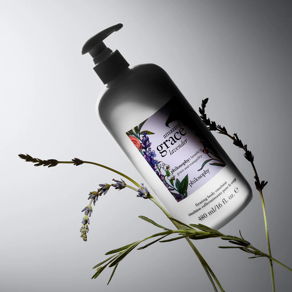 Philosophy lavender firming body lotion bottle with pump next to fresh lavender sprigs on white background