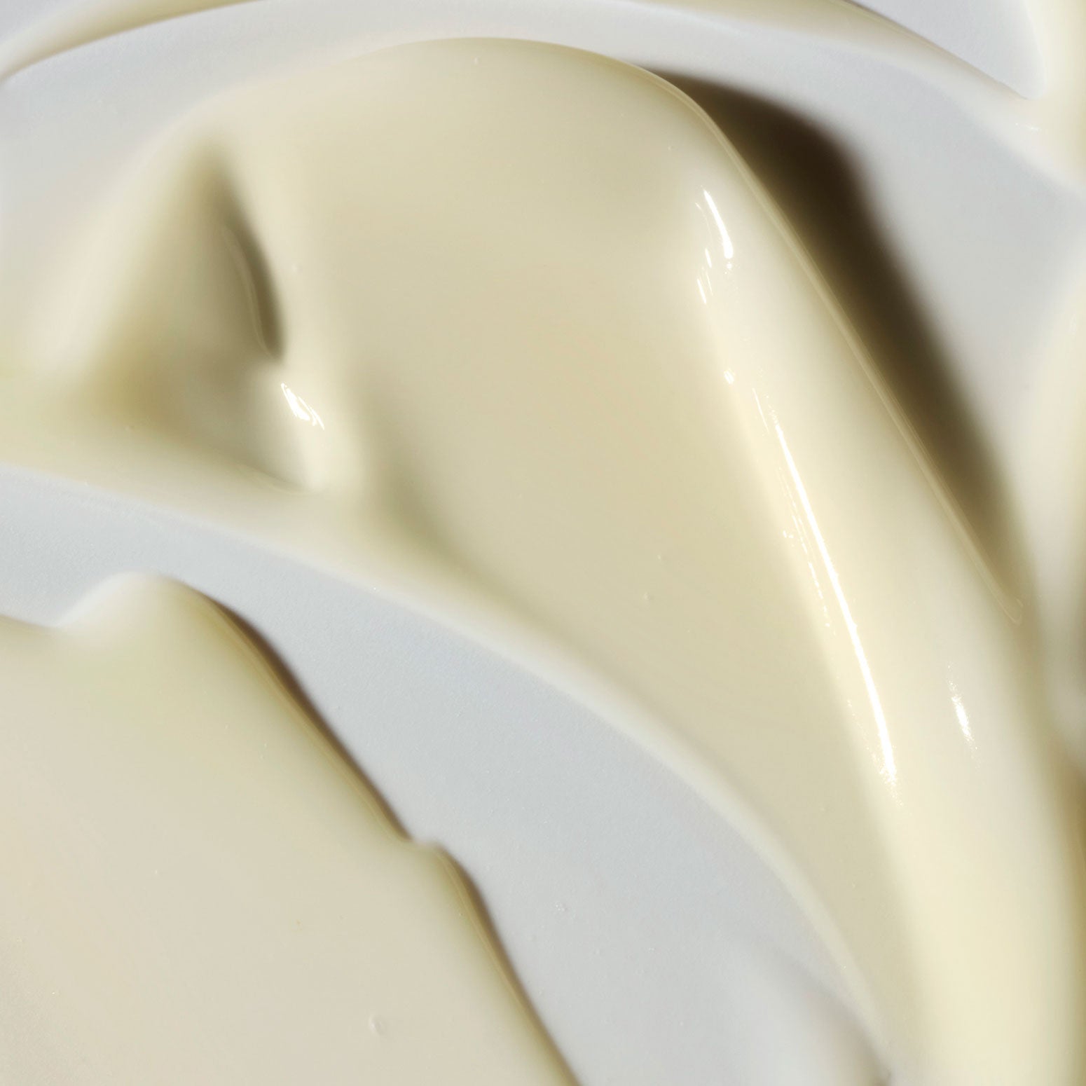 Close-up texture of Philosophy Purity Made Simple moisturizer cream swirled on a white surface