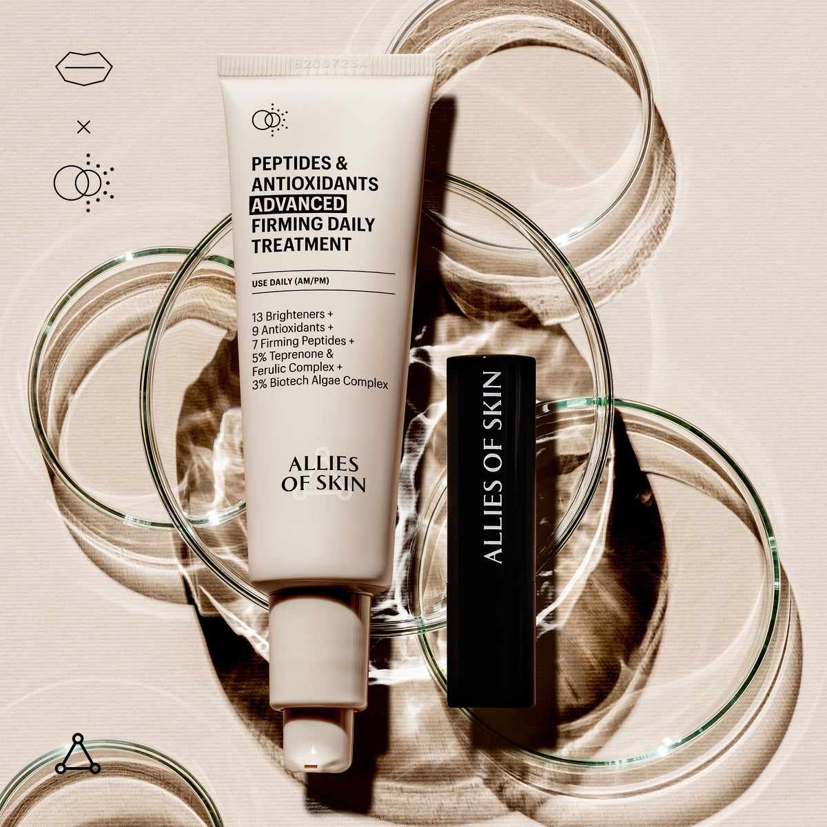 Allies of Skin lip repair balm next to Peptides and Antioxidants Advanced Firming Daily Treatment tube on glass rings