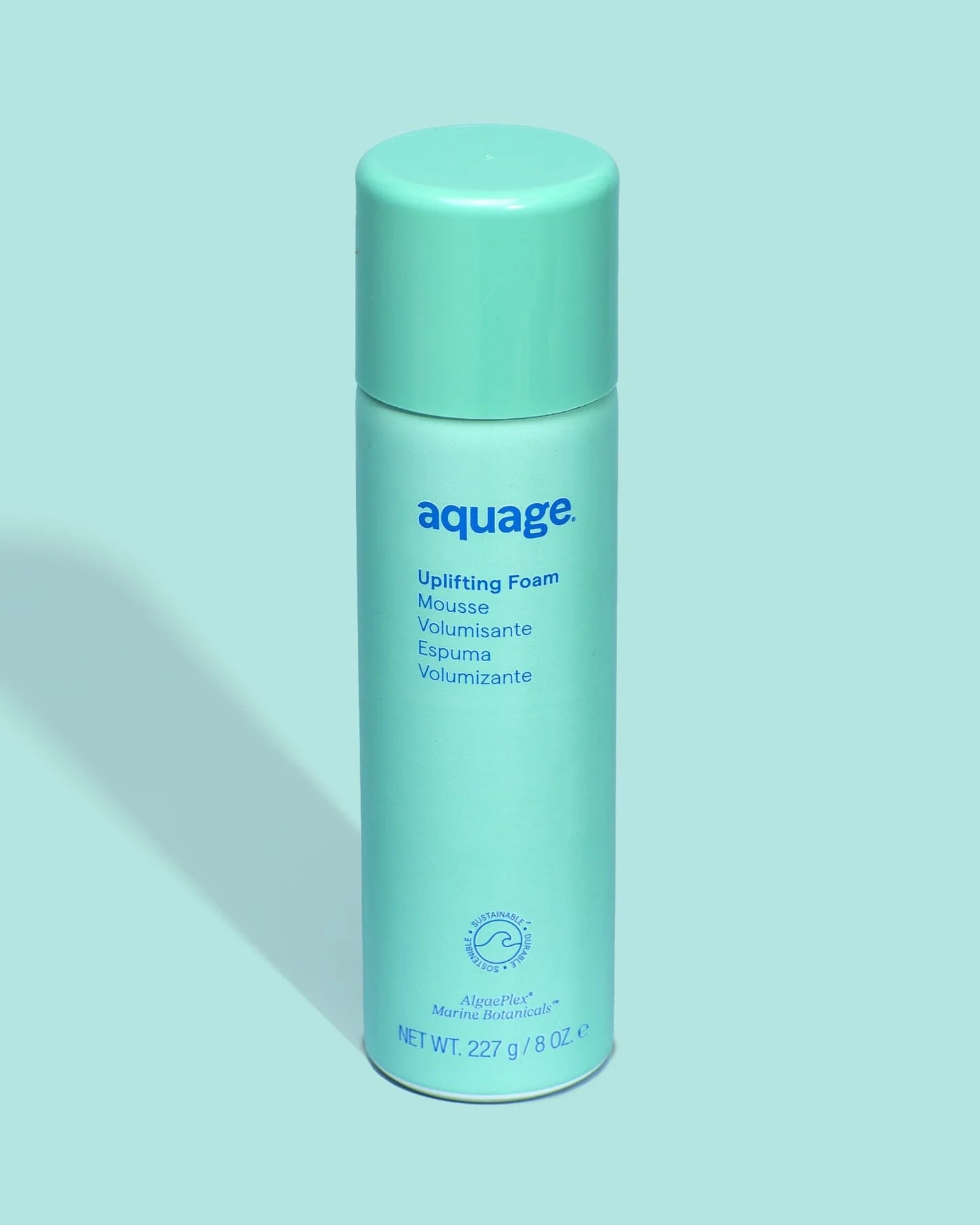 Aquage Uplifting Foam hair mousse in a light teal bottle with blue text on a matching background