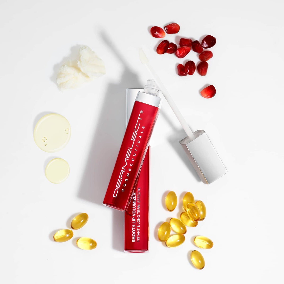 Dermelect lip volumizer for fuller lips red gloss tube with applicator wand and pomegranate seeds and oil capsules