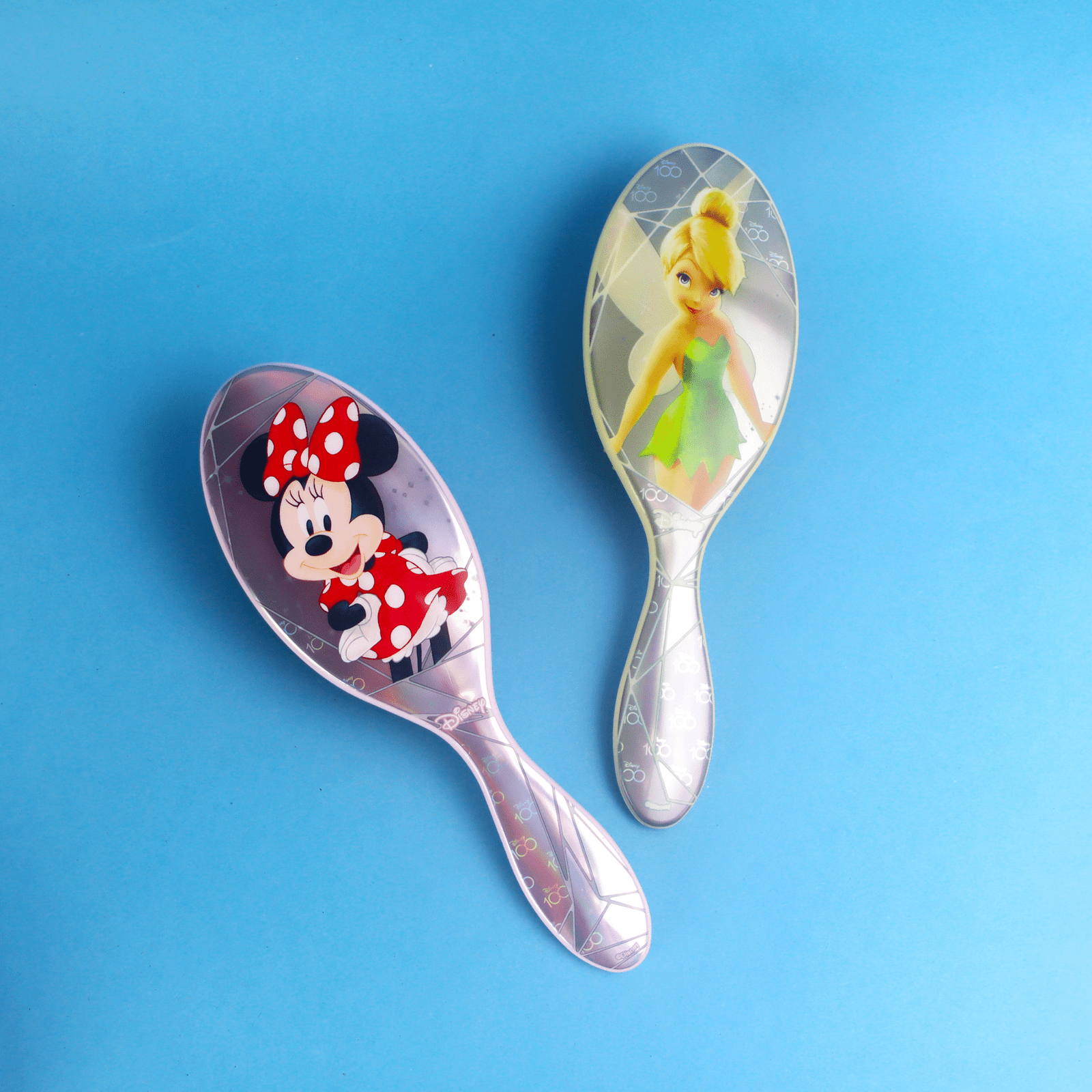 Disney 100 wet brush featuring Minnie Mouse and Tinkerbell designs on a colorful background