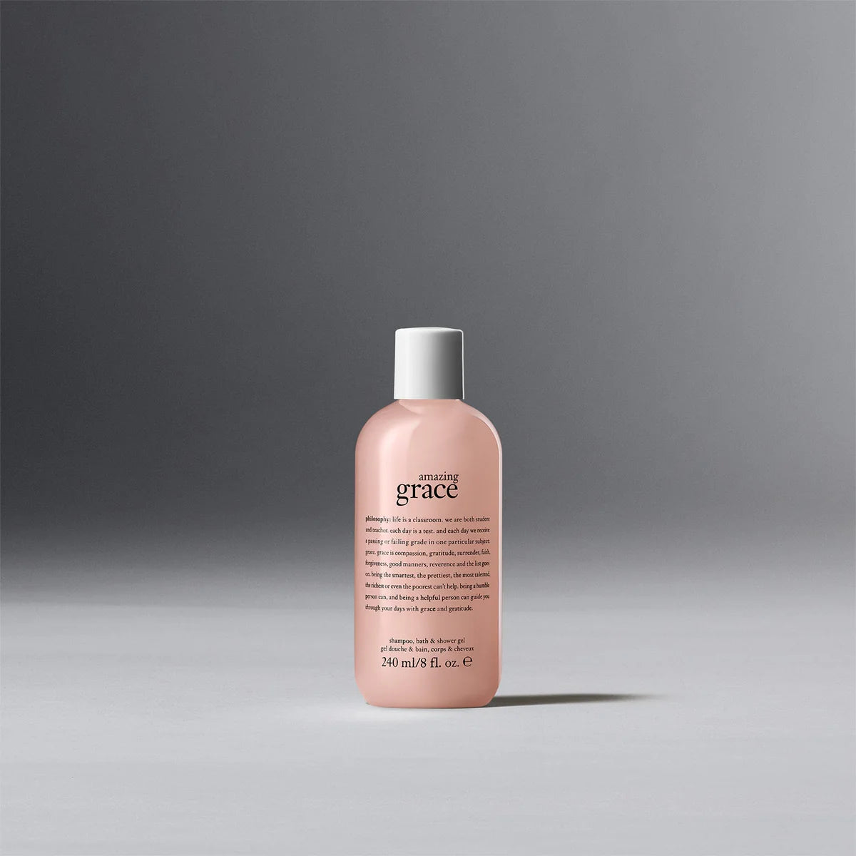 Philosophy amazing grace shower gel in a pink 240 ml bottle with white cap on gray background