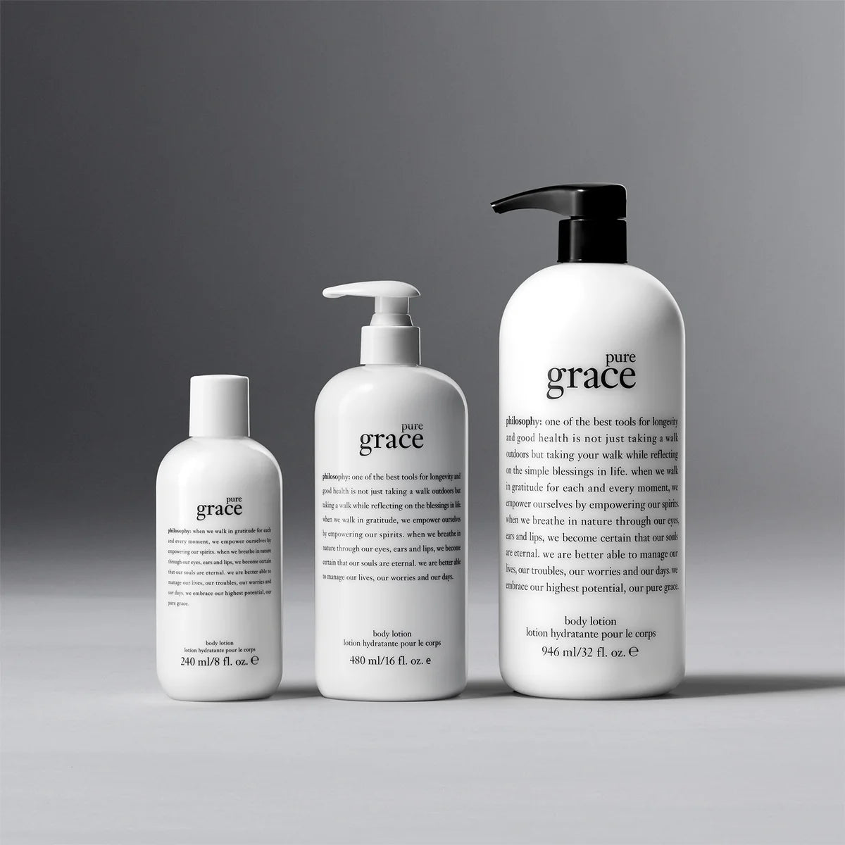Three Philosophy Pure Grace lotion bottles in varying sizes with white packaging and black and white pumps
