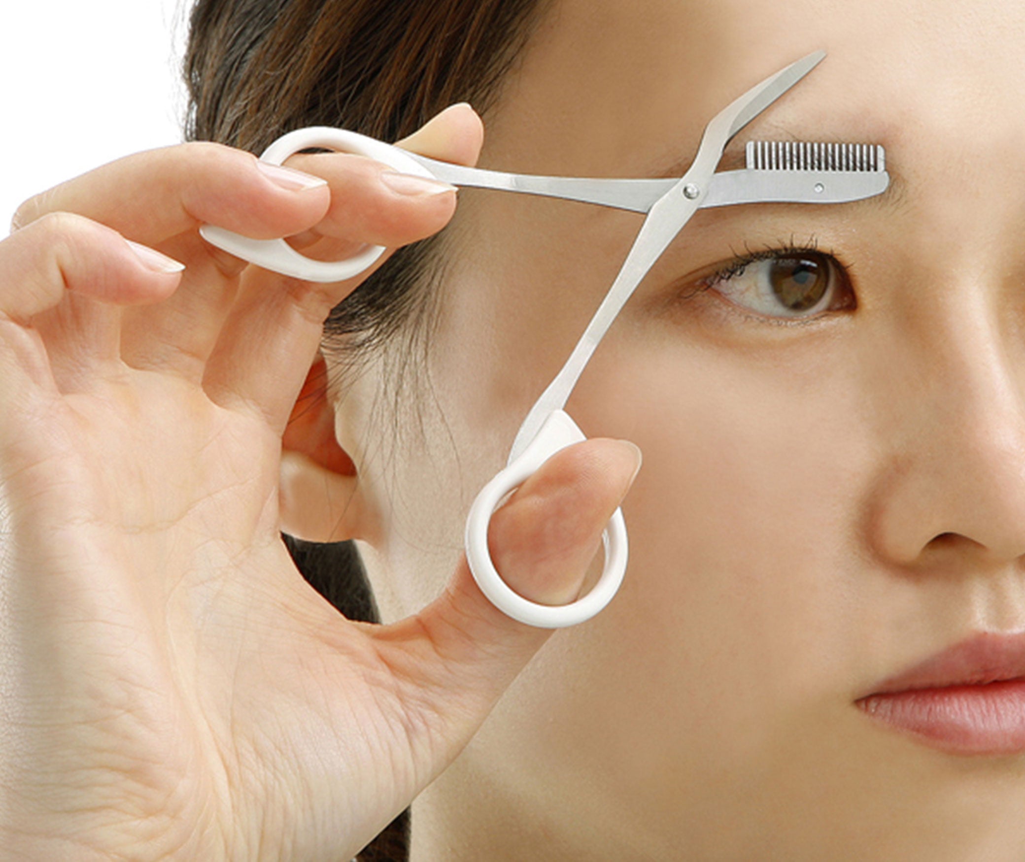 Seki Edge stainless steel eyebrow scissors being used for precise eyebrow grooming