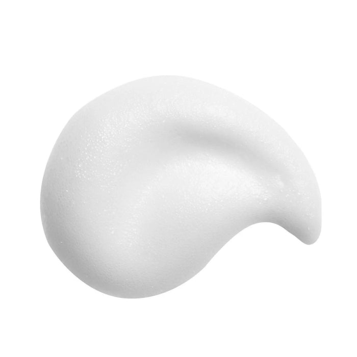 Close-up of white mousse texture of St. Tropez tan remover mousse on a white background
