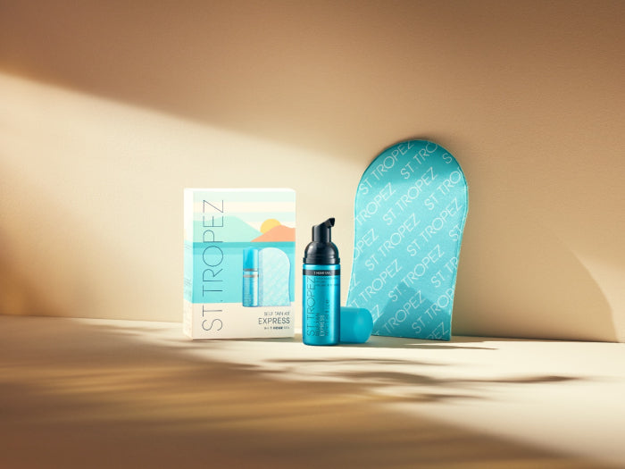 St Tropez self tan kit with bronzing mousse, applicator mitt, and packaging in blue and white
