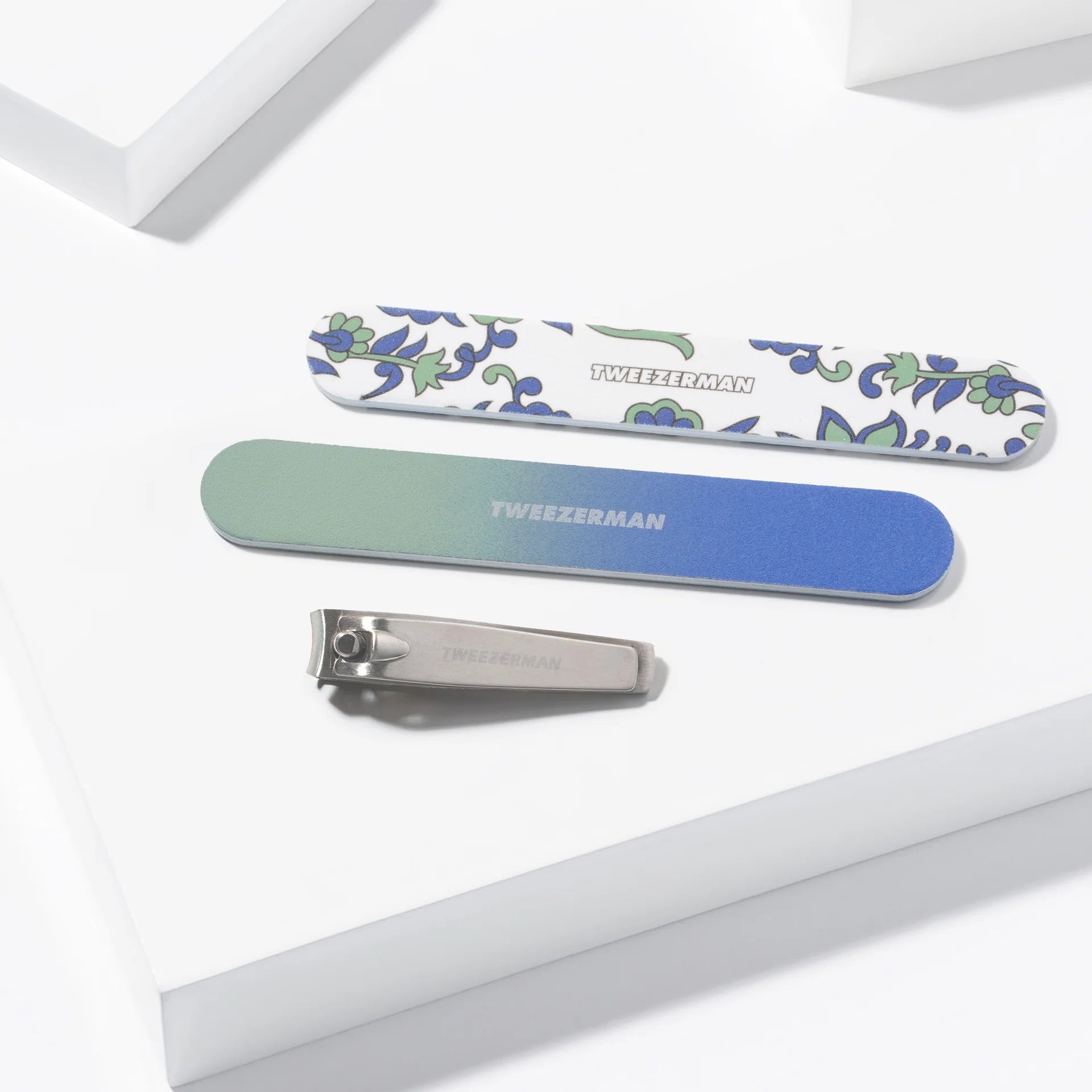 Tweezerman nail care products including a nail clipper and two nail files in decorative designs