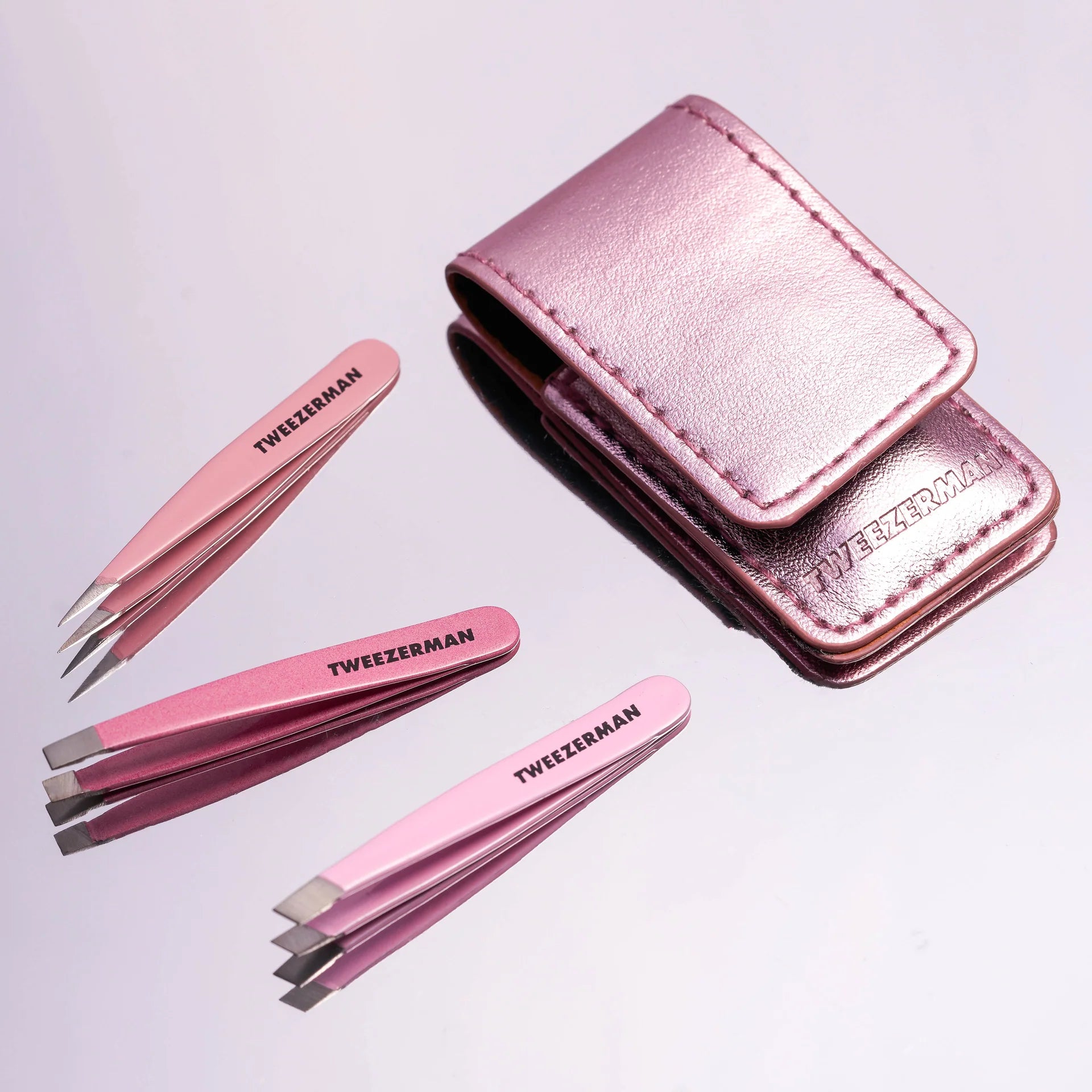 Tweezerman tweezer set with three precision tweezers in pink and a stylish carrying case