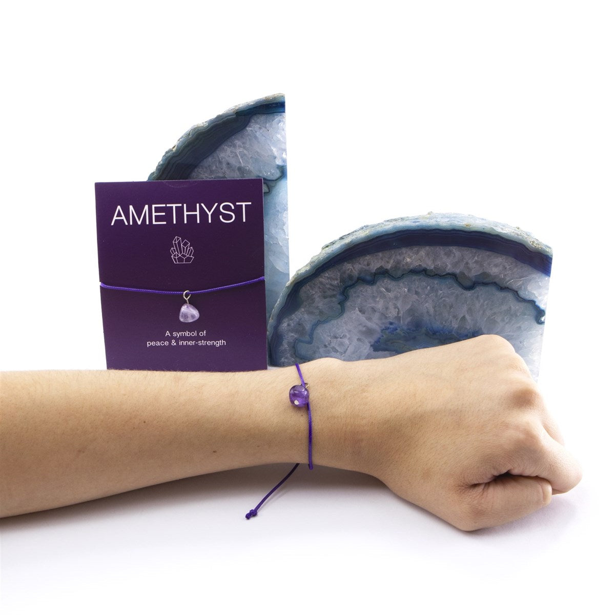 Purple amethyst bracelet on wrist with card showing symbol of peace and inner strength