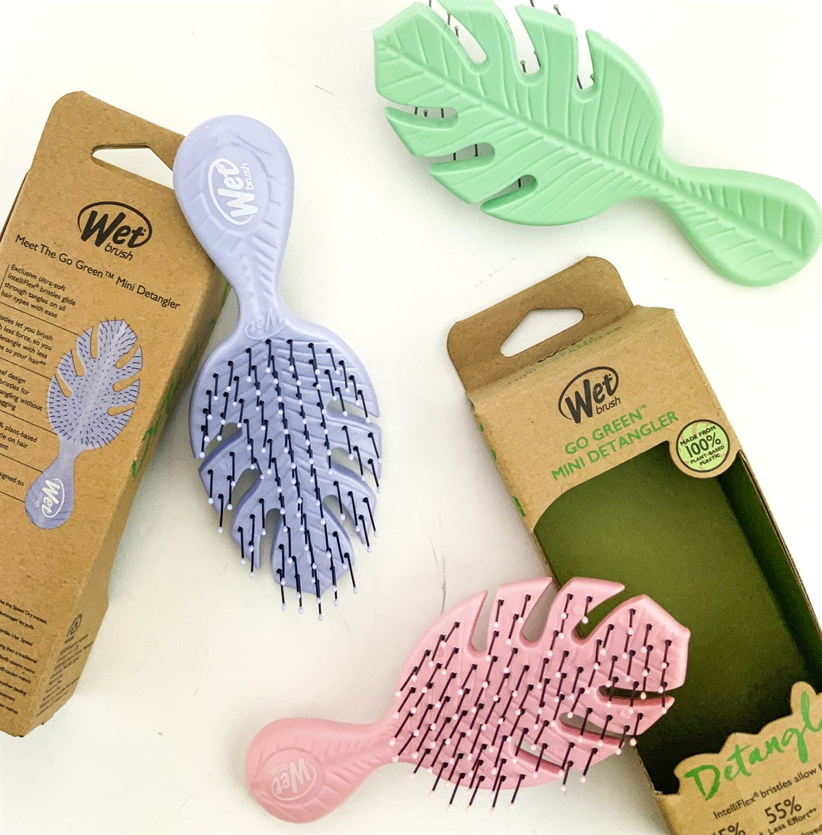 Wet Brush eco-friendly mini hairbrushes in pastel green pink and lavender with leaf design and packaging