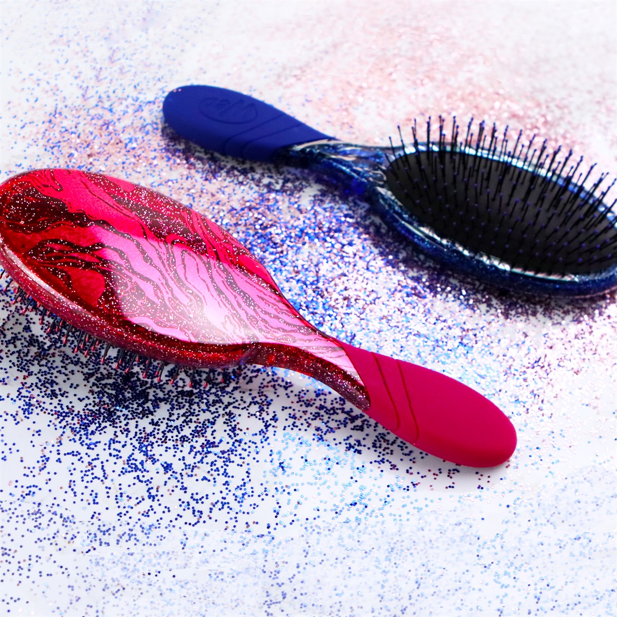 Wet Brush sparkle finish detangling brush with red and blue glitter handles on a white background