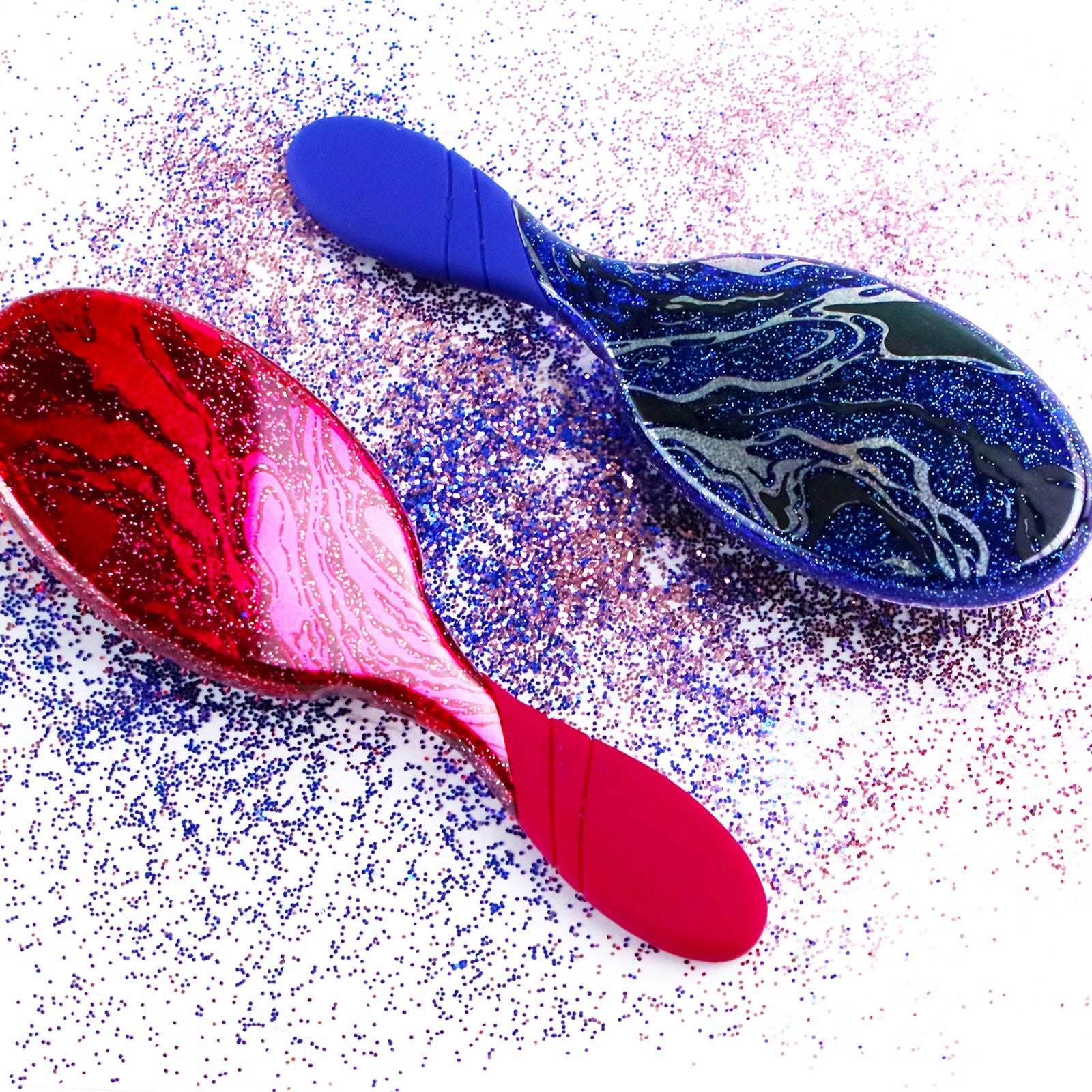 Wet Brush sparkle finish detangling brush in red and blue with glittery swirls and comfortable handles