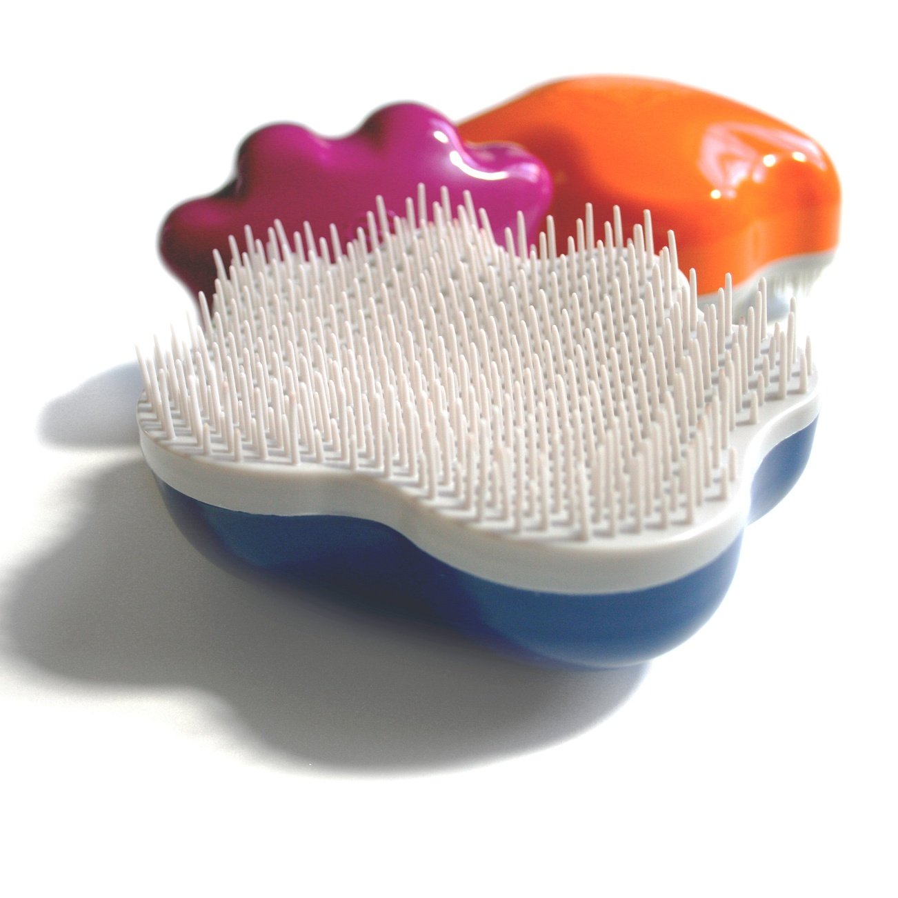 Groom Genie Teeny pet brush with white bristles and colorful blue purple and orange handle