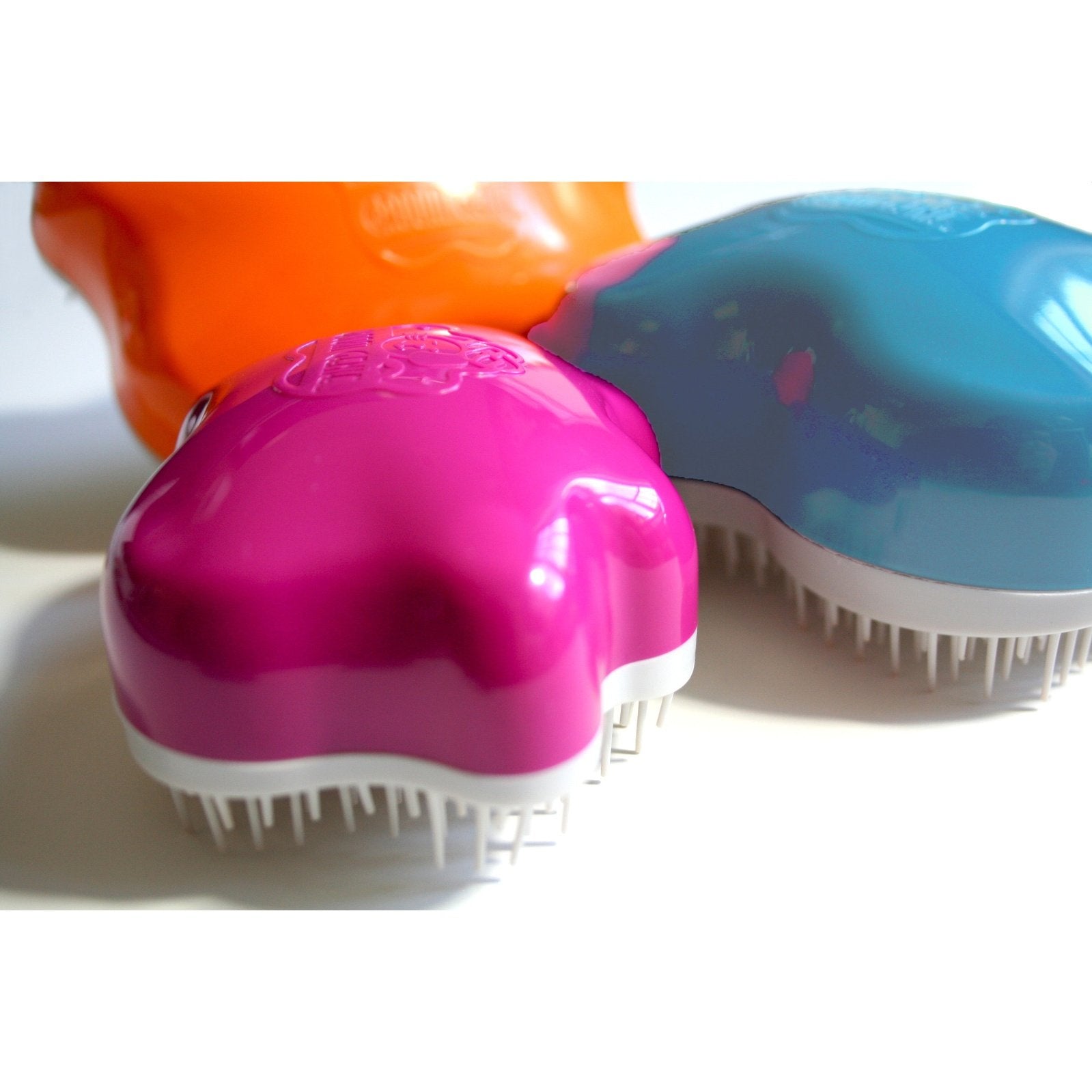 Colorful Groom Genie Teeny pet brush in pink, blue, and orange for small pet grooming