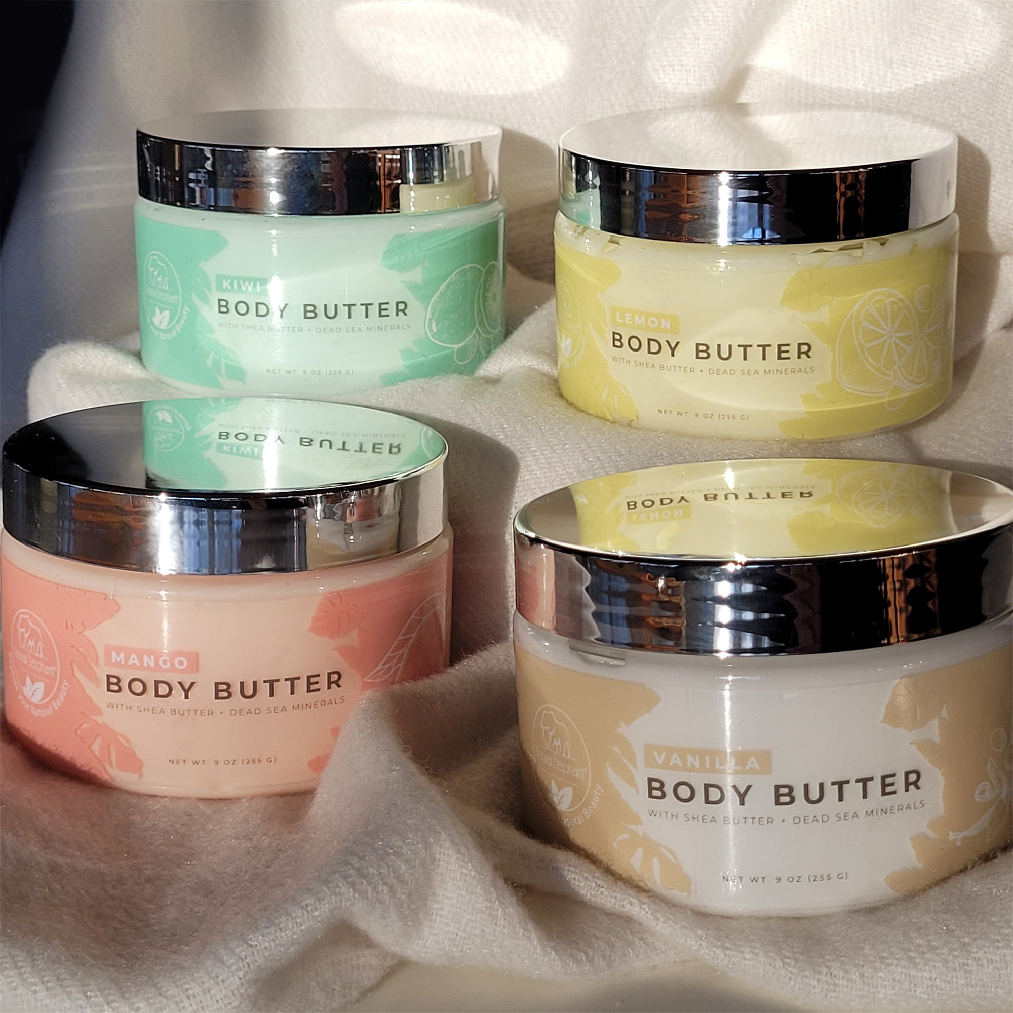 Natural Elephant Dead Sea Shea Body Butter in assorted flavors including mango, kiwi, lemon, and vanilla