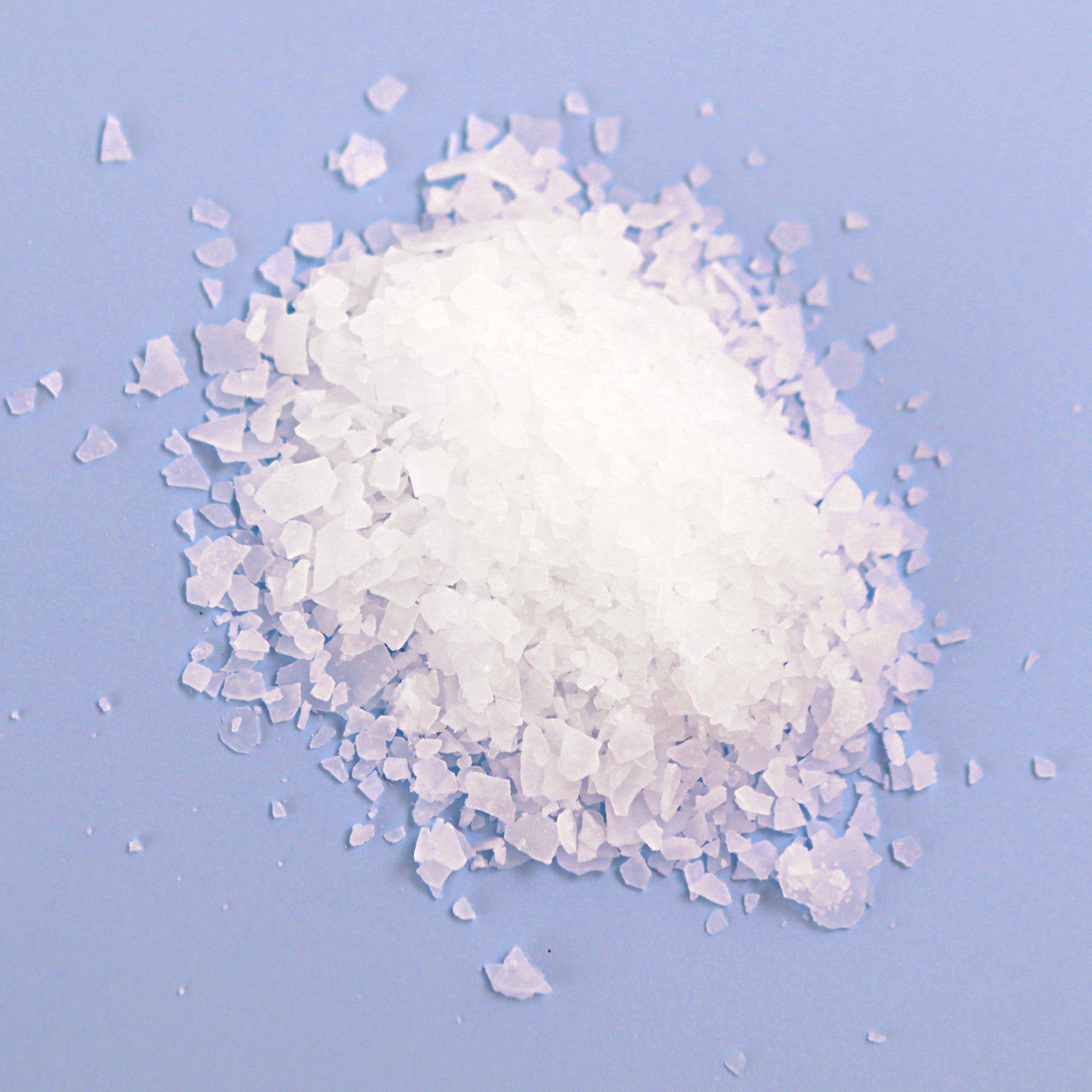 Natural Elephant Dead Sea Salt crystals for natural magnesium bath soak on blue background