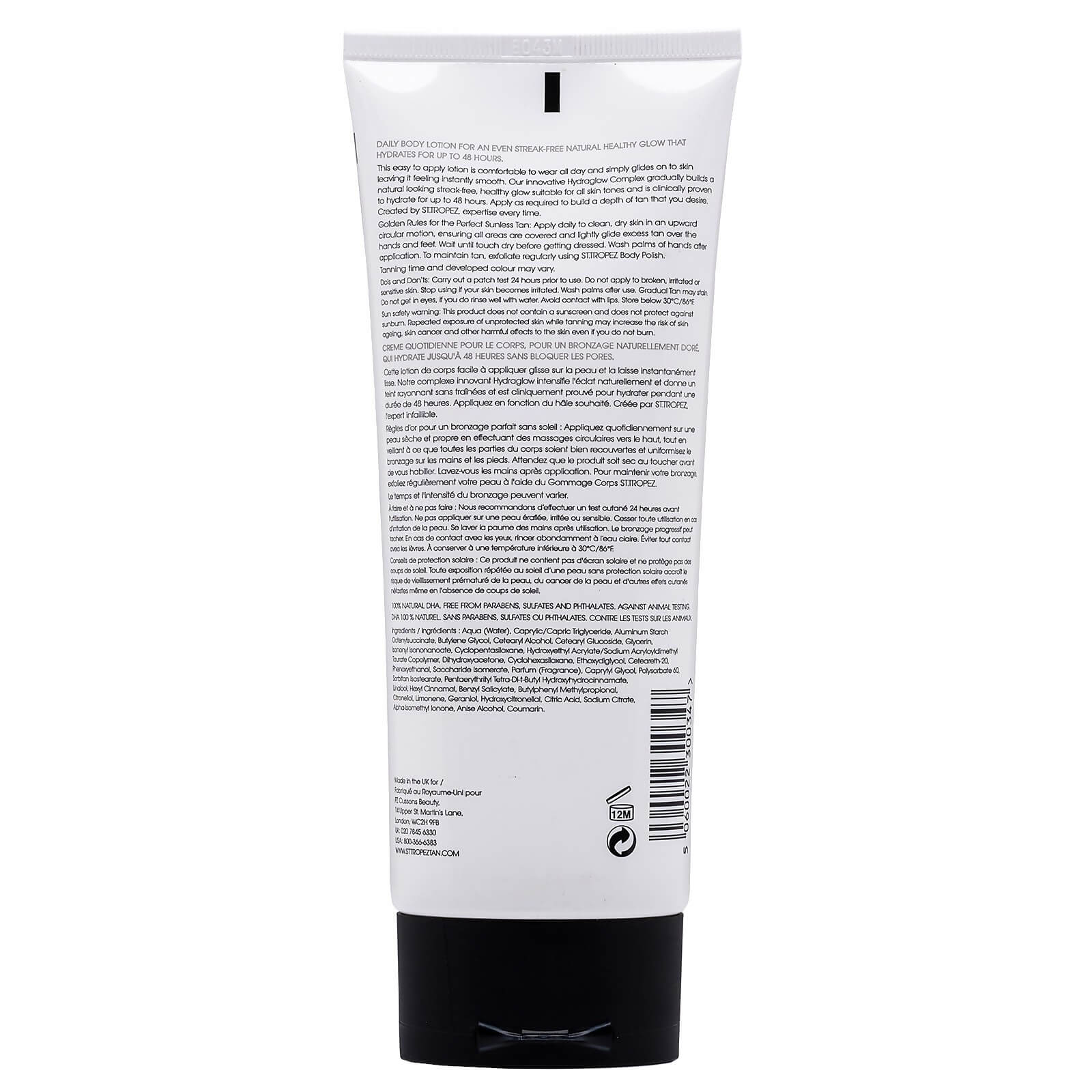 Back view of St Tropez light medium gradual tan self-tanning body cream tube with detailed usage instructions