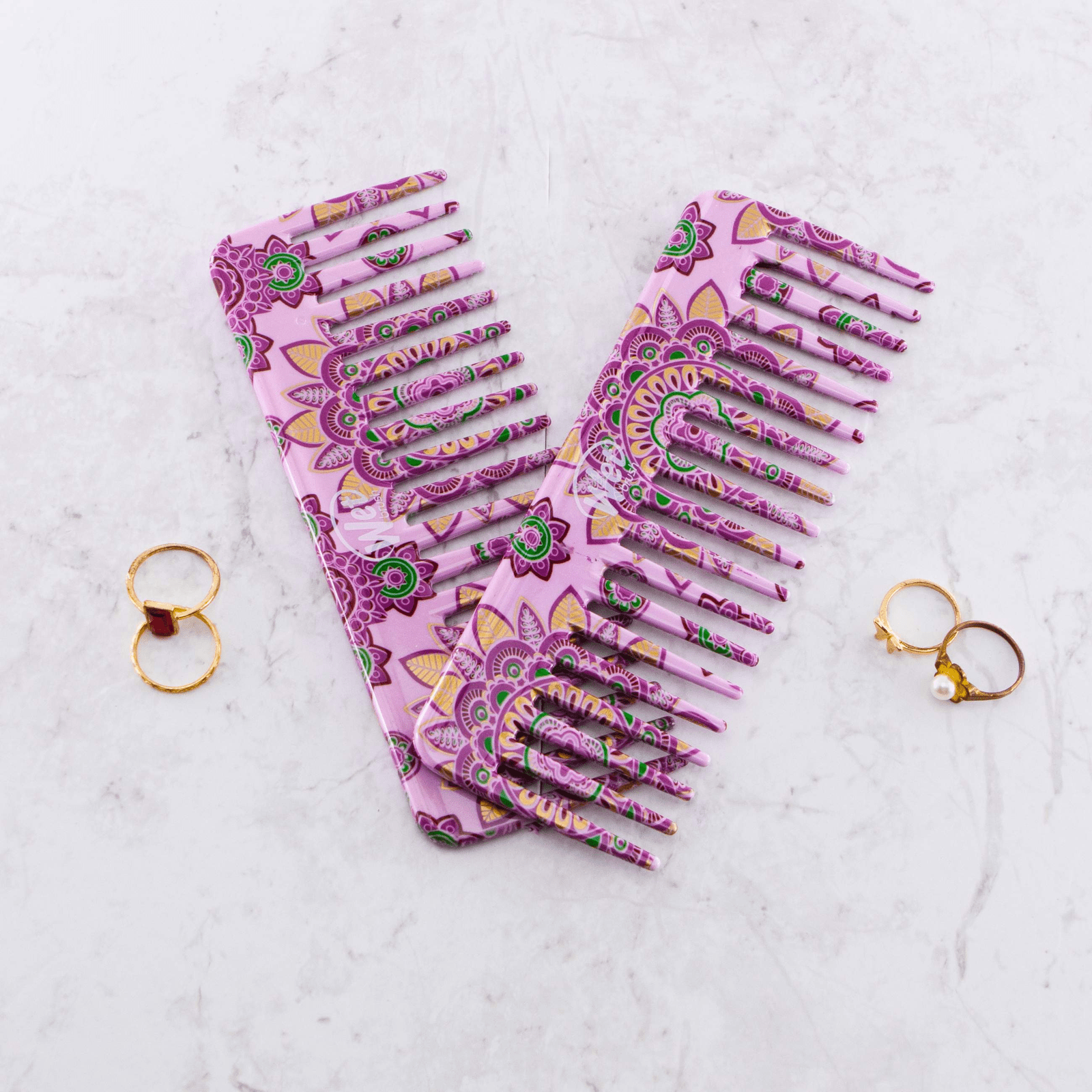Wet Brush Moroccan print detangler comb featuring a purple and green floral design on a marble surface