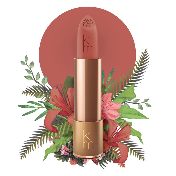 Karen Murrell natural lipstick in rose terracotta shade with rose gold case and floral background