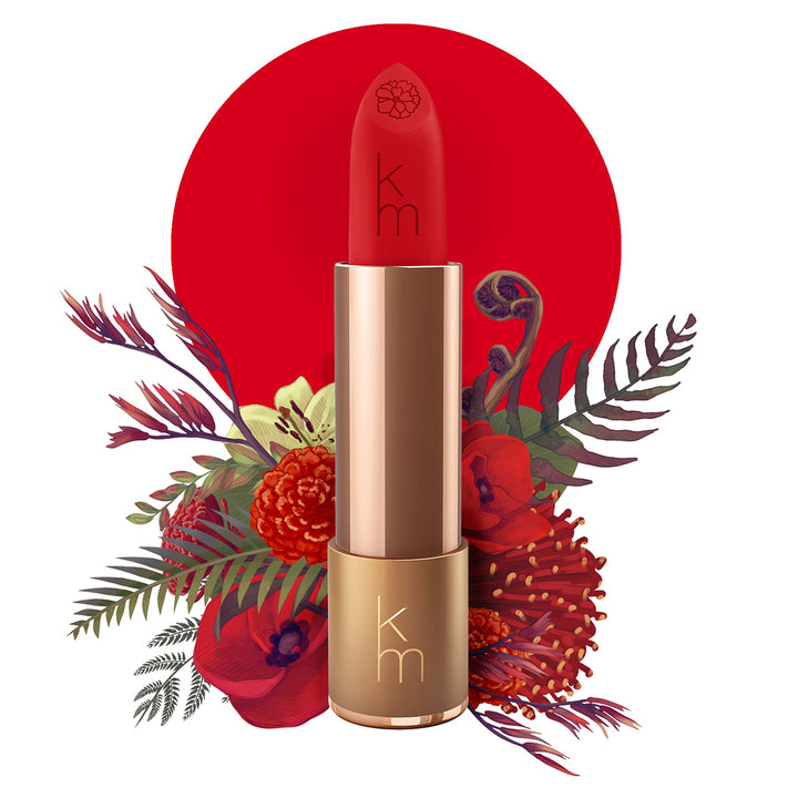 Karen Murrell natural lipstick red matte bullet in gold tube with floral background and embossed KM logo