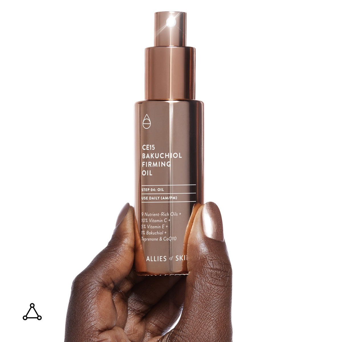 Allies of Skin CE15 Bakuchiol firming oil rose gold pump bottle held by hand showing label and texture