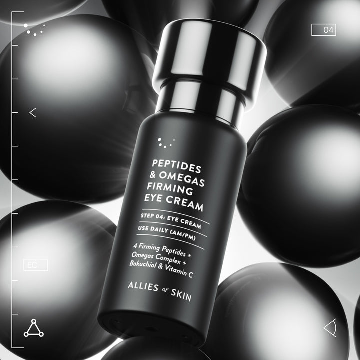 Allies of Skin firming eye cream with peptides in sleek black bottle against metallic spheres