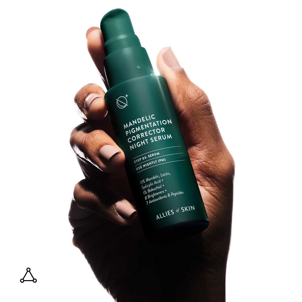 Hand holding green Allies of Skin bottle of mandelic acid pigmentation serum against white background