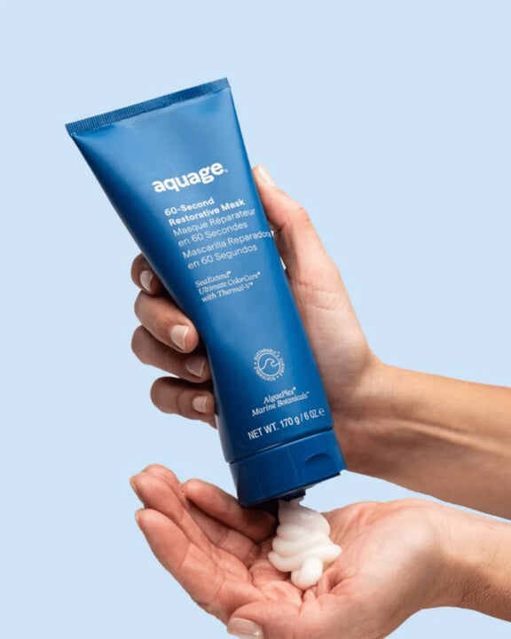 Aquage 60-Second Mask for Hair in a blue tube with a hand dispensing the hair mask for hair