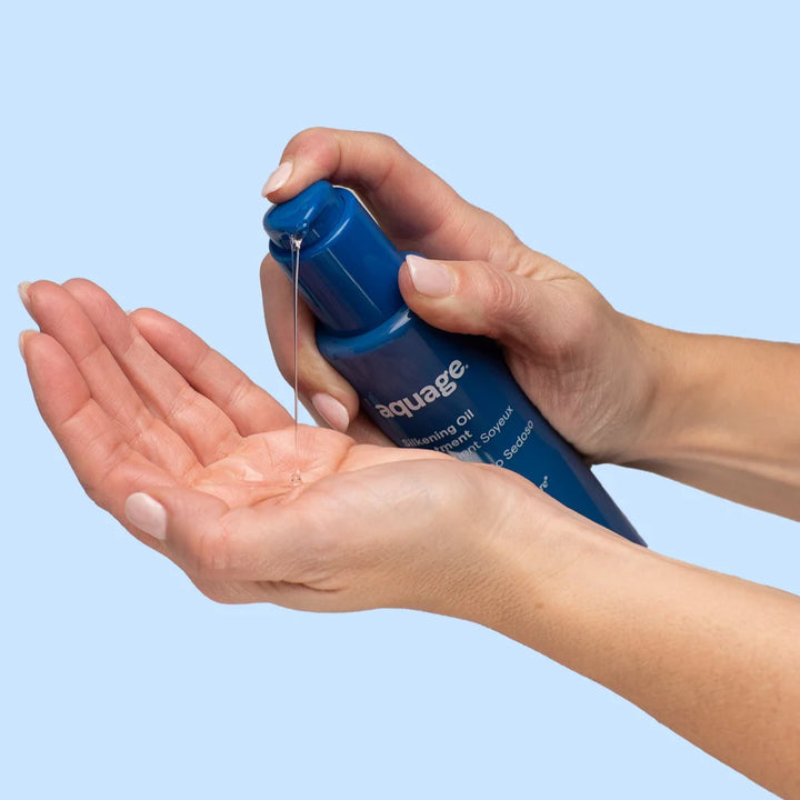 Aquage hair treatment for losing hair in a blue pump bottle dispensing oil into a hand