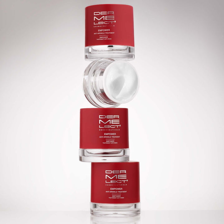Dermelect Empower Anti-Wrinkle Treatment red jars stacked with one open jar showing white cream
