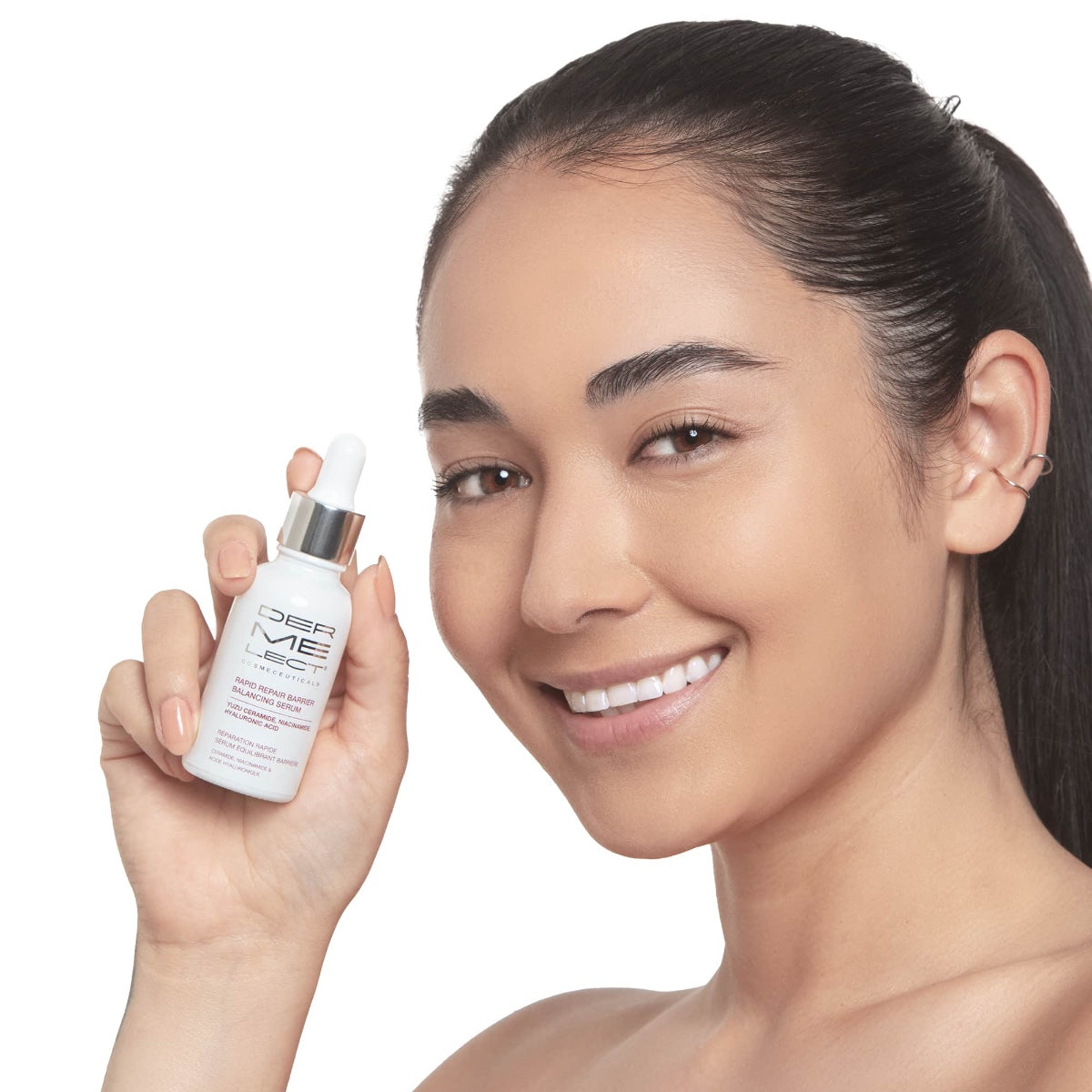 Smiling woman holding Dermelect Rapid Repair Serum dropper bottle next to clear glowing skin
