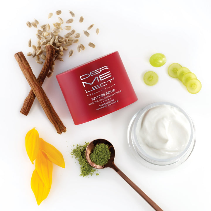 Dermelect Redness Rehab cream red jar with open white cream and natural ingredients like licorice oats grapes and green powder