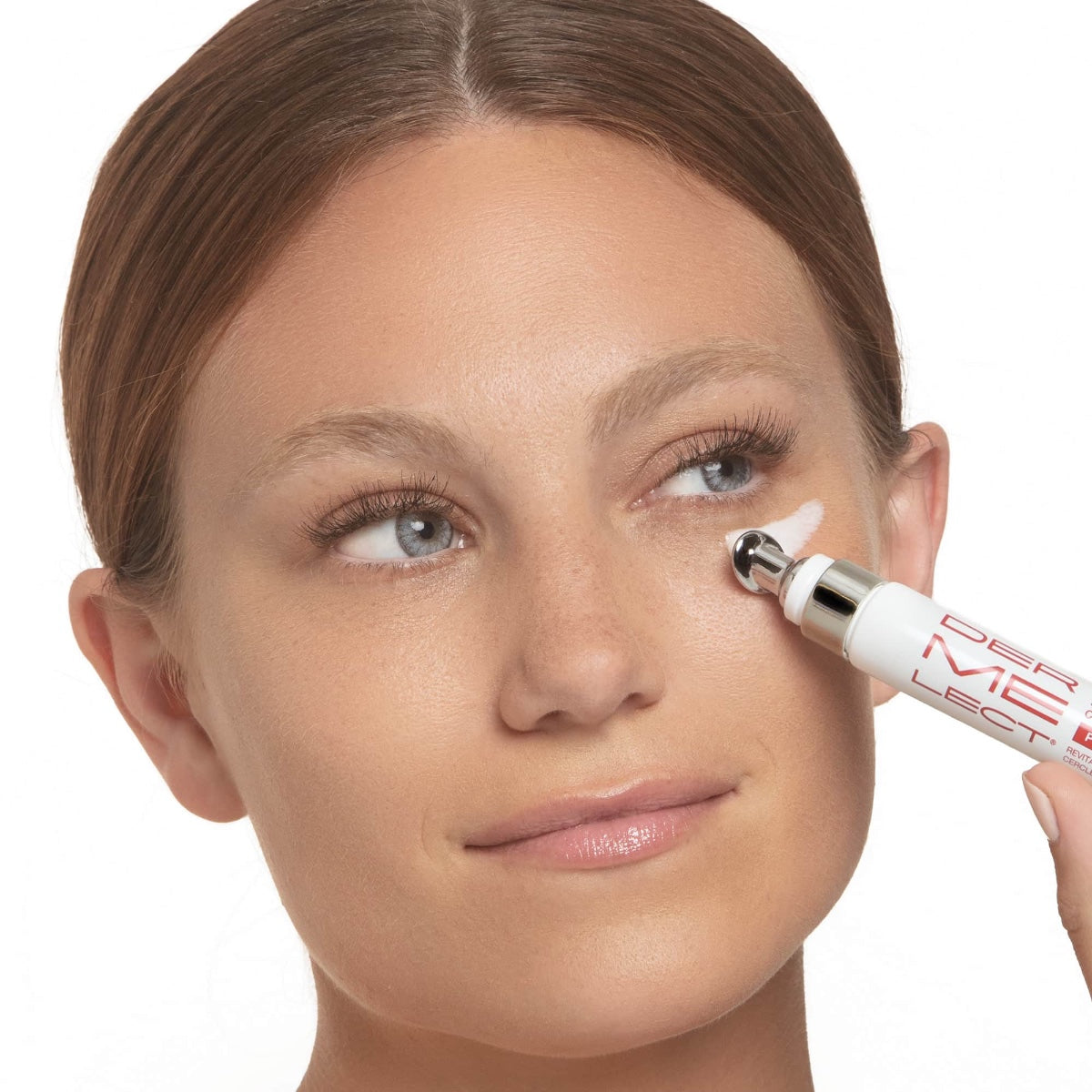 Model applying Dermelect Revitalite for dark circles under eye with metal roller applicator
