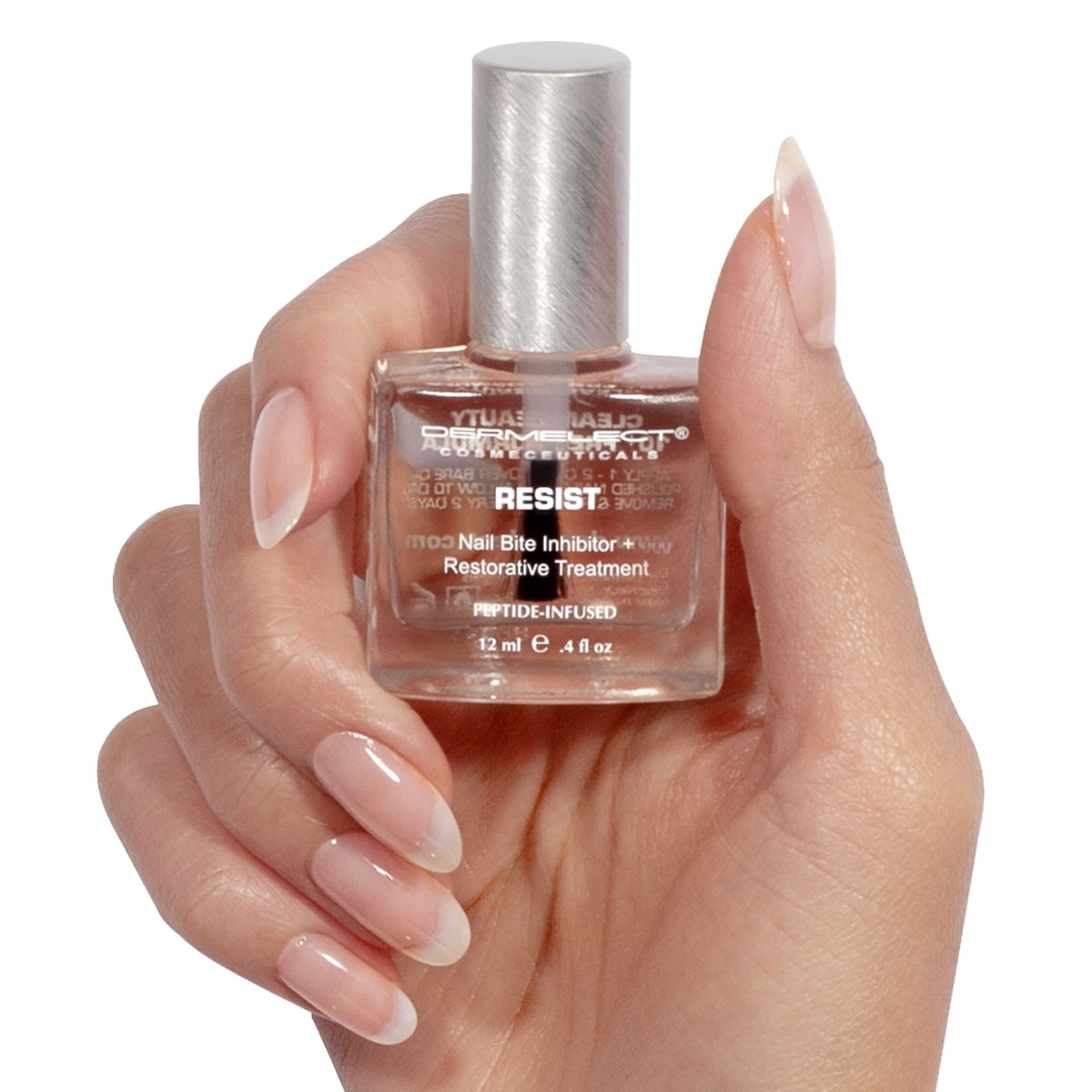 Dermelect Resist nail bite inhibitor treatment bottle held by manicured hand showing clear restorative polish