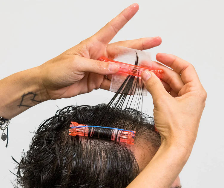 Hands using Seki Edge end papers for precise hair cutting and styling techniques