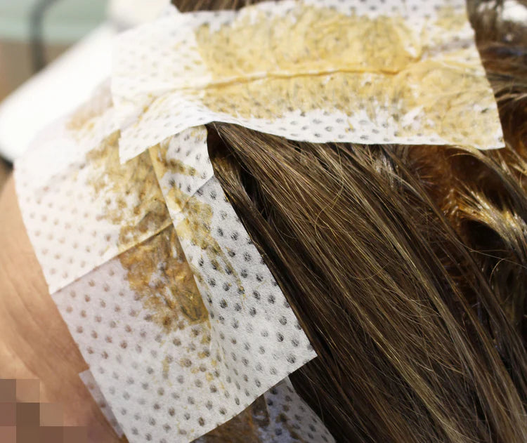 Seki Edge end papers for hair coloring treatment, shown applied to hair for effective dye absorption