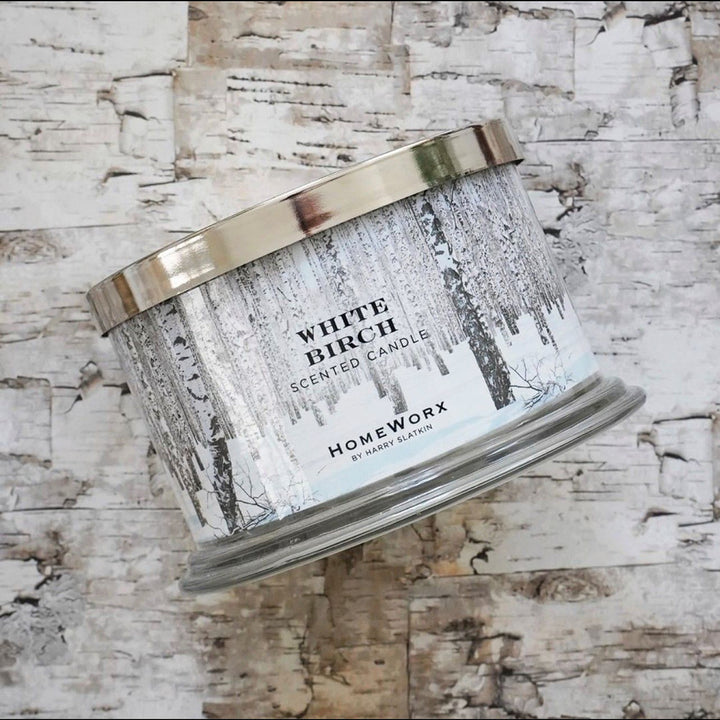 HomeWorx by Slatkin white birch scented candle in a silver-lidded glass jar with birch tree design
