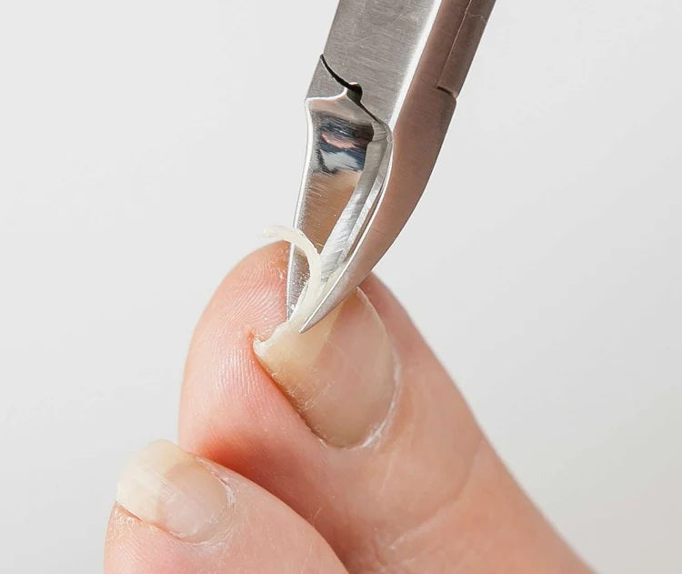 Seki Edge nail nipper trimming a hangnail on a fingertip for precise nail care