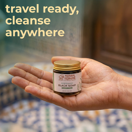 Natural Elephant Moroccan black soap travel size in a jar held in hand, ideal for on-the-go cleansing