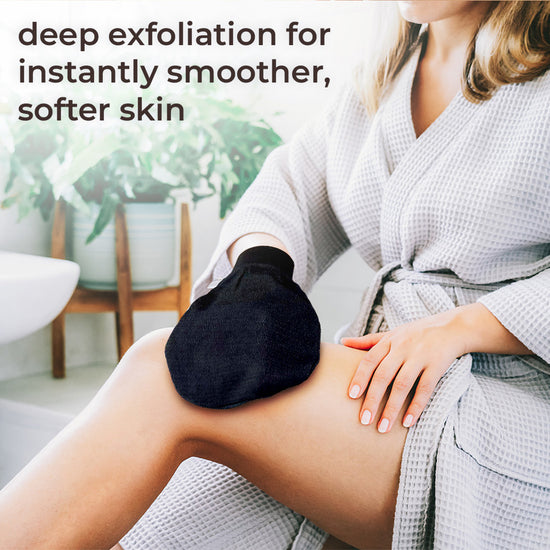 Natural Elephant Moroccan exfoliating glove kit used for deep exfoliation on leg in white bathrobe