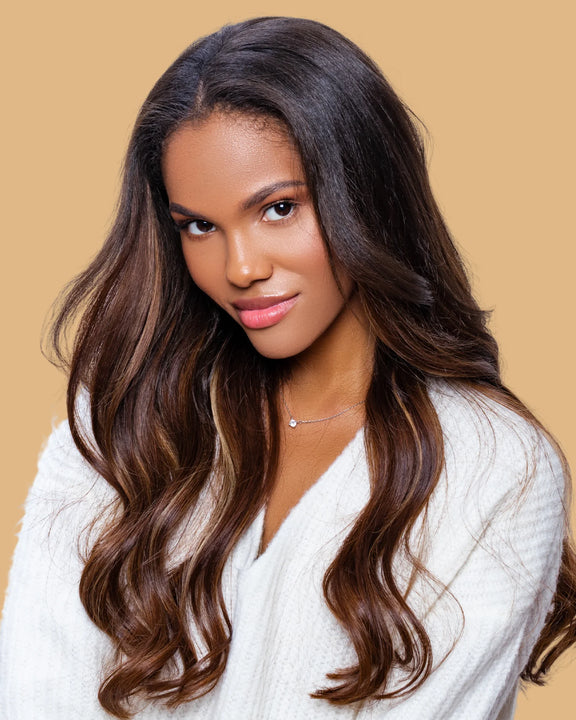 Woman with long shiny hair showcasing smooth texture using One N Only Argan Oil for hair care