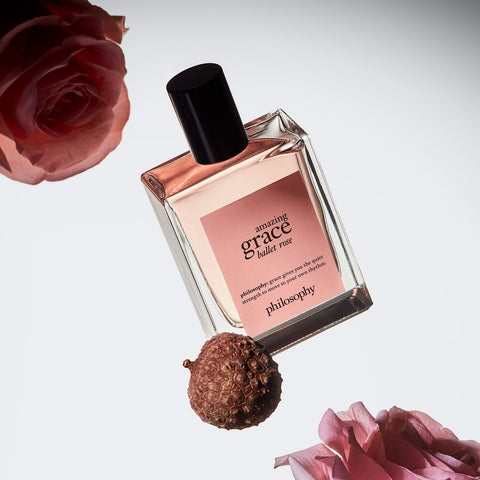 Philosophy Amazing Grace Ballet Rose perfume bottle surrounded by pink roses and natural elements