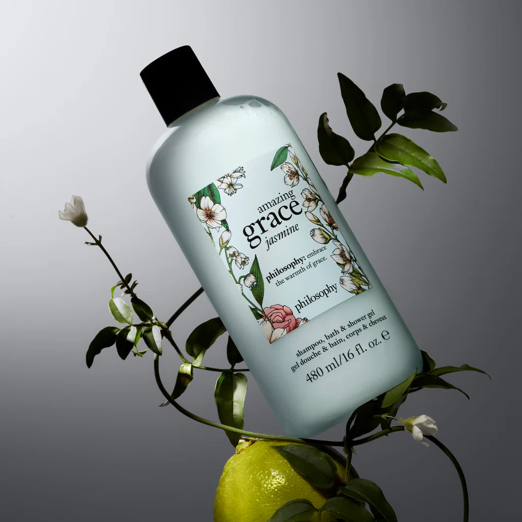 Philosophy Amazing Grace Jasmine shower gel bottle surrounded by green leaves and white flowers