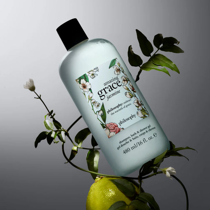 Philosophy Amazing Grace Jasmine shower gel bottle surrounded by green leaves and white flowers