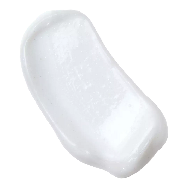 Swatch of Philosophy Amazing Grace shimmering lotion showing creamy white texture with subtle shimmer