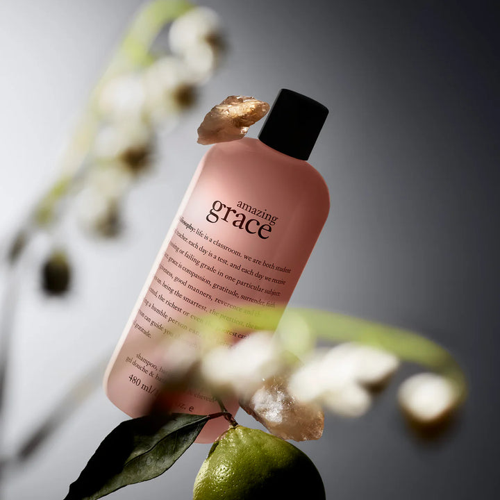 Philosophy amazing grace shower gel bottle with black cap and floral background