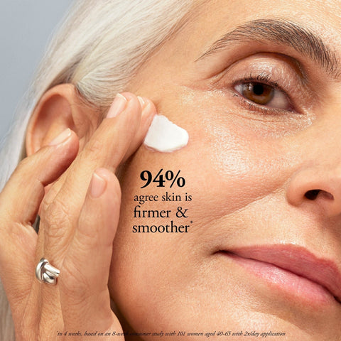 Philosophy anti-aging face and neck cream being applied to mature woman's cheek for firmer smoother skin
