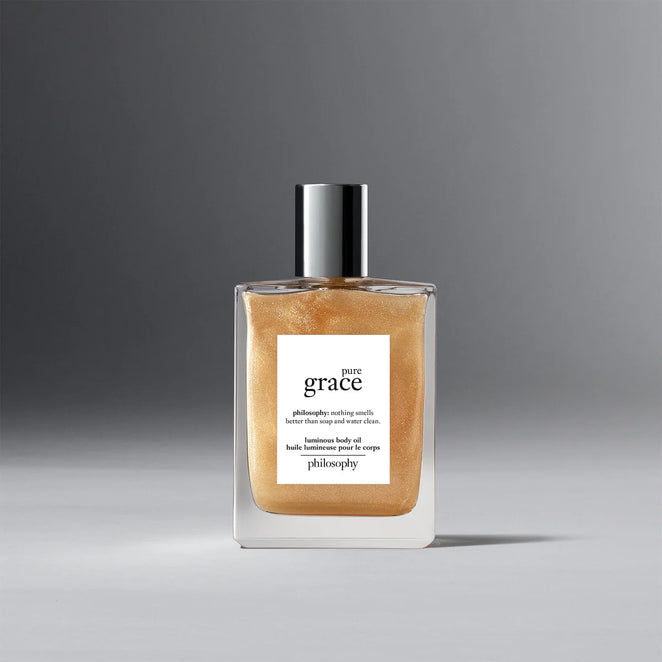 Philosophy Pure Grace body oil in clear bottle with silver cap and shimmering golden liquid