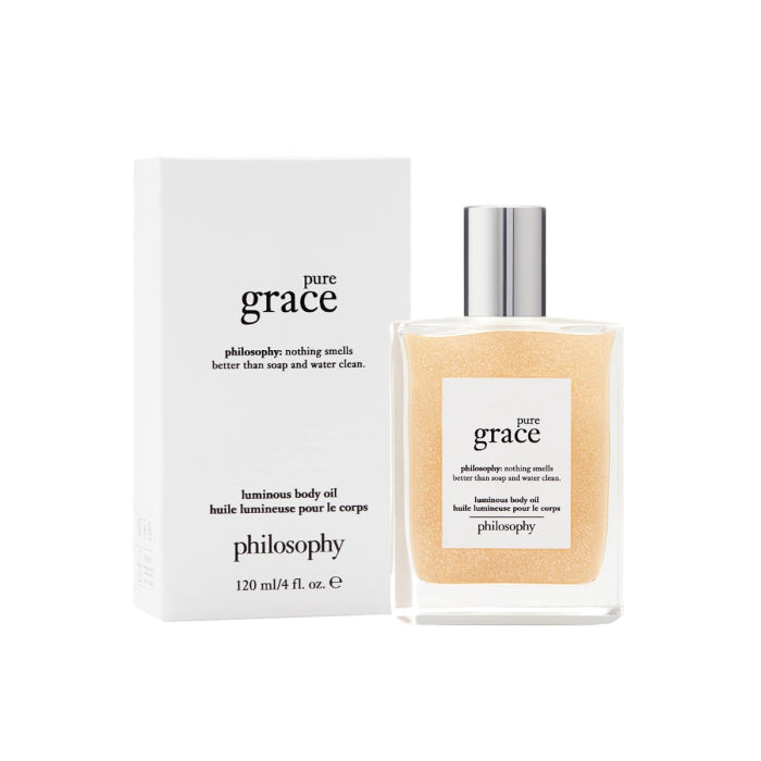 Philosophy Pure Grace body oil luminous formula in clear bottle with silver cap next to white packaging box